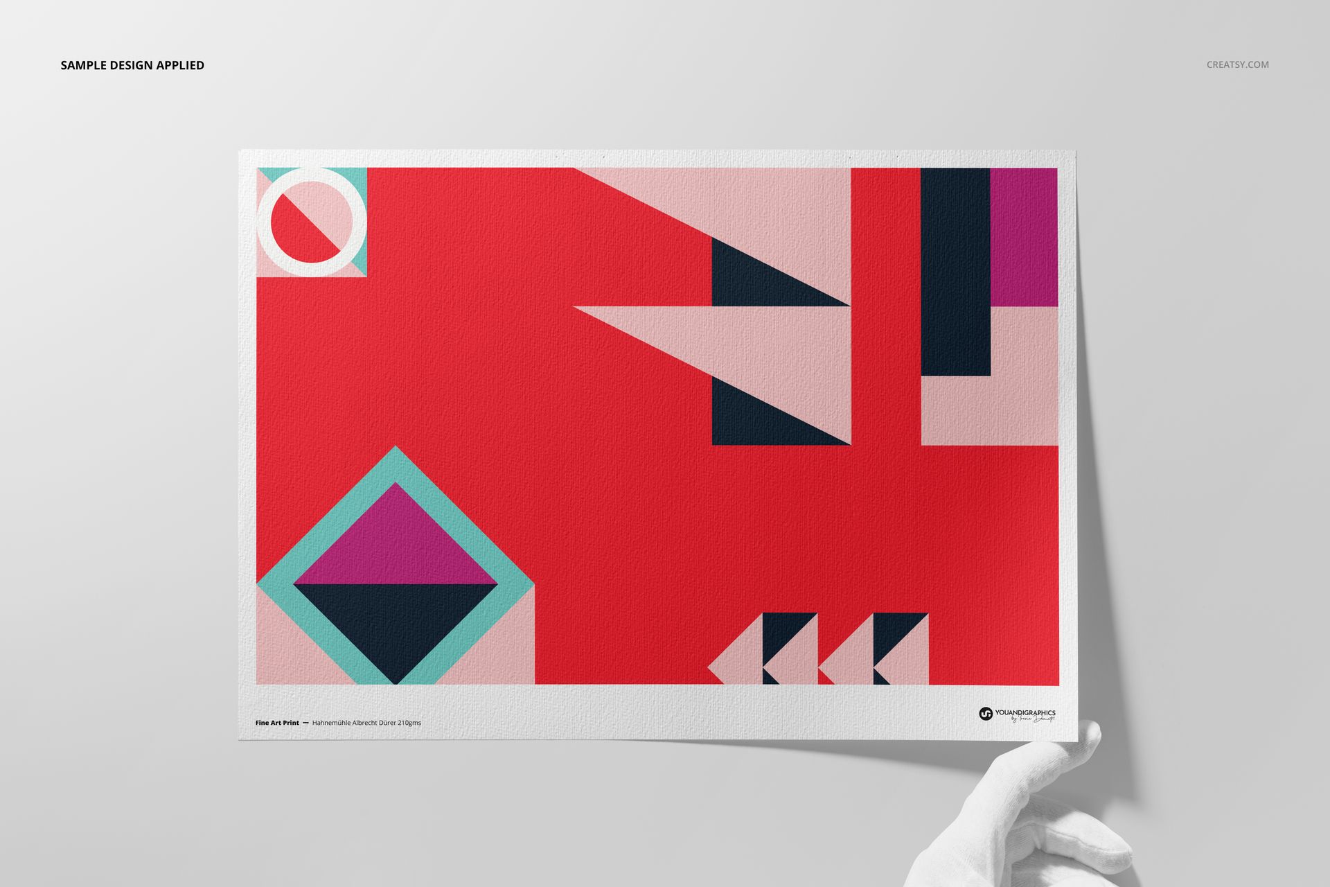 Mockup of a Hahnemühle Albrecht Dürer print with modern geometric artwork, shown against a light background with gloved hand.