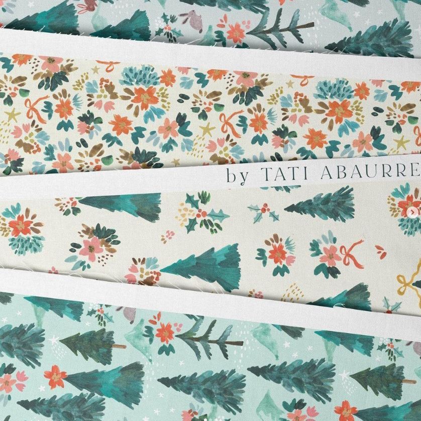 Cotton fabric sample mockup showing three pieces of fabric with hand-painted Christmas tree and floral patterns in green and pink tones.