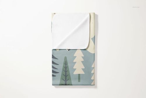 Folded fleece blanket with rounded corners featuring a forest tree pattern in muted blue, green, and cream tones.