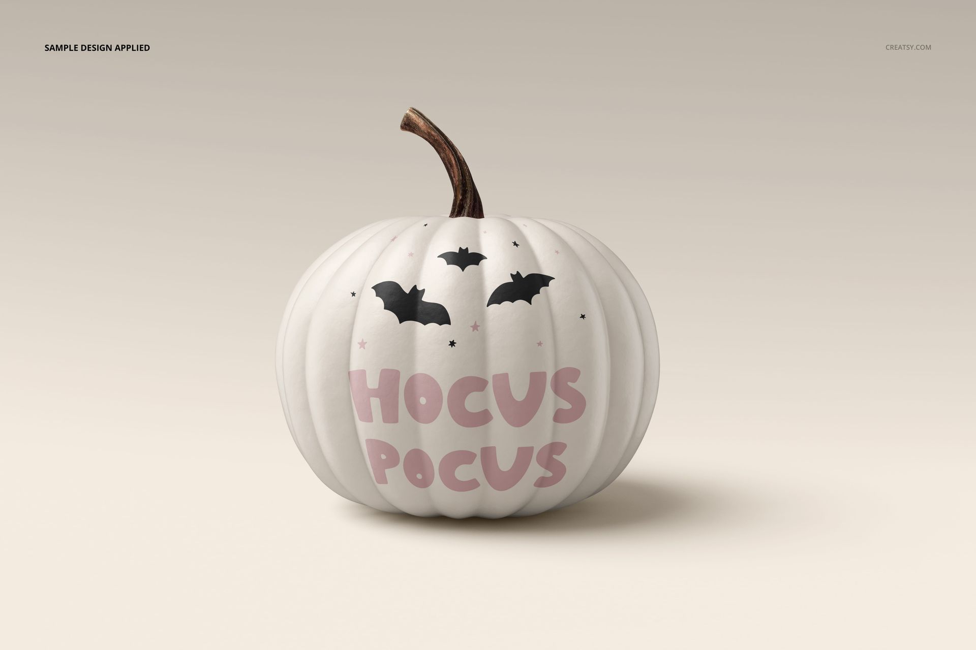 Single white pumpkin mockup featuring pink lettering and bat graphics, shown against a beige gradient backdrop.