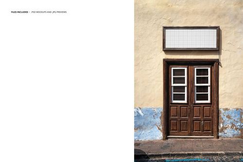 Old building facade featuring a double wooden door and a grid-patterned empty signboard mockup above.