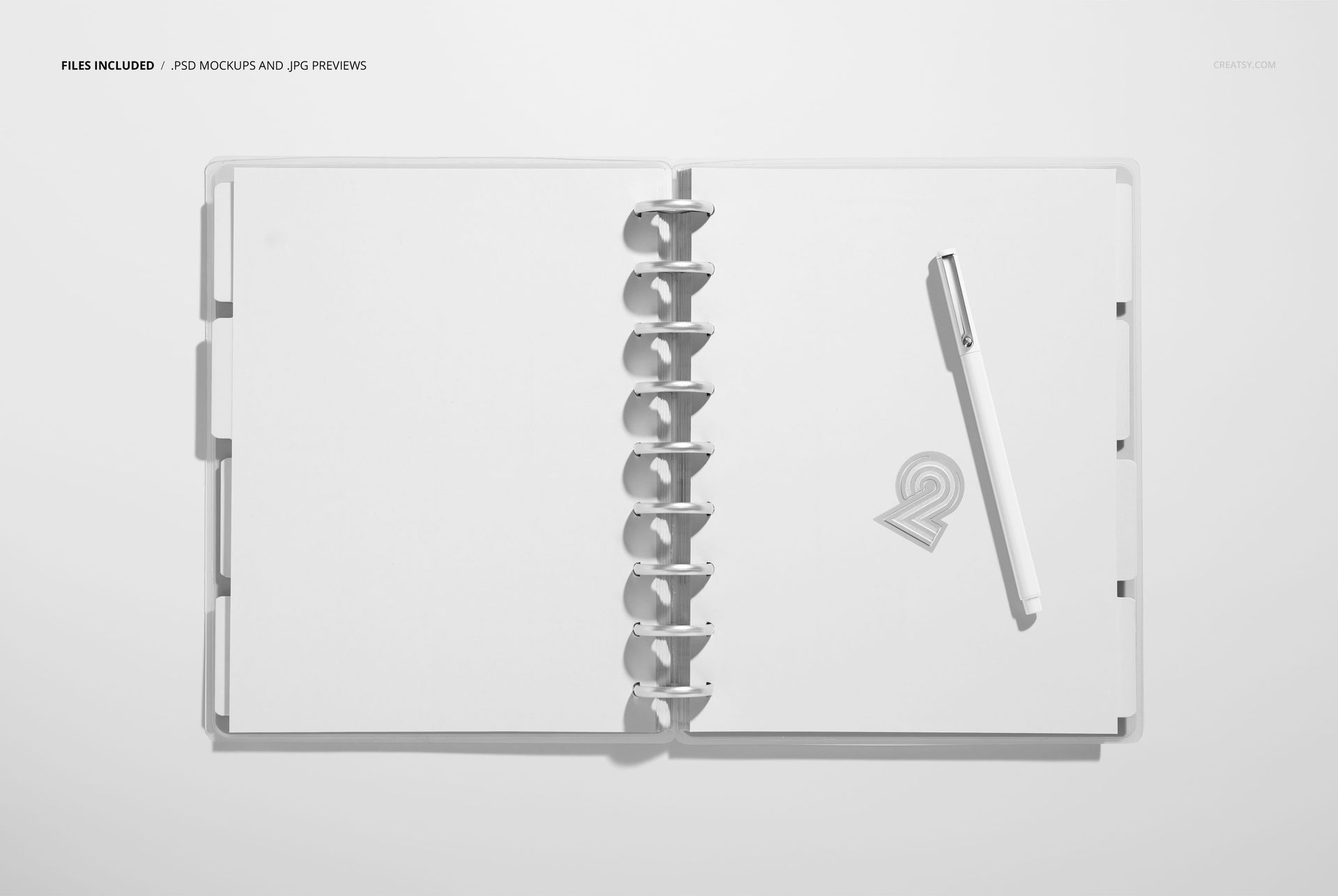Top view of a spiral-bound planner mockup featuring empty pages and a pen placed on the right page, minimal background.