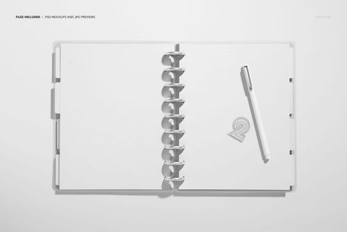 Top view of a spiral-bound planner mockup featuring empty pages and a pen placed on the right page, minimal background.