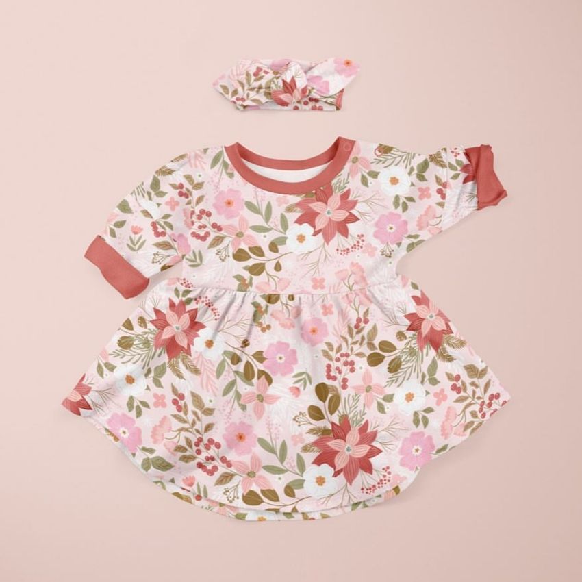 Baby jersey dress mockup with long sleeves and matching headband, both featuring a pink and red floral pattern on a light background.