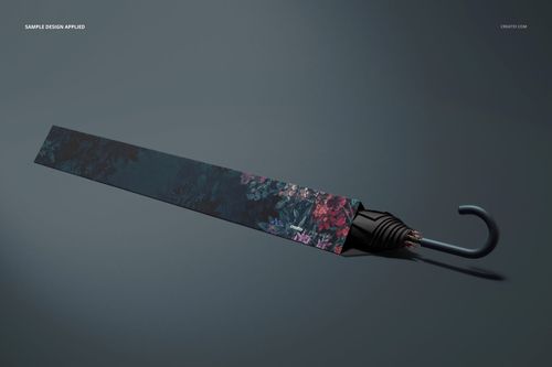 Umbrella packaging mockup featuring a sleek dark floral design, displayed diagonally with the umbrella handle visible.