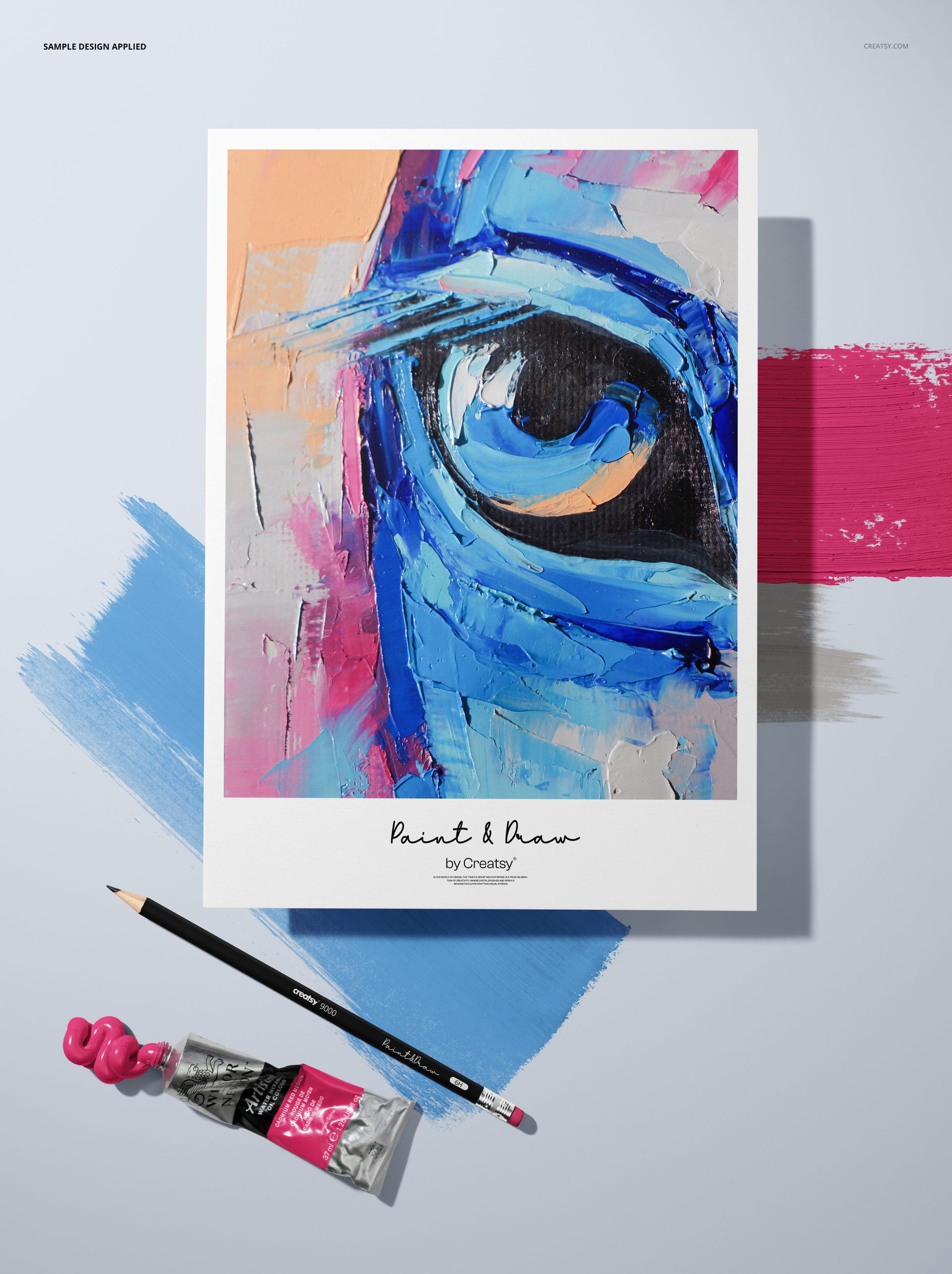 Textured paper mockup featuring a colorful abstract eye painting, with a pencil and paint tube on a light background.