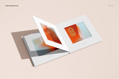 Open artbook mockup with two white hardcover pages displayed, featuring abstract orange and beige artwork.