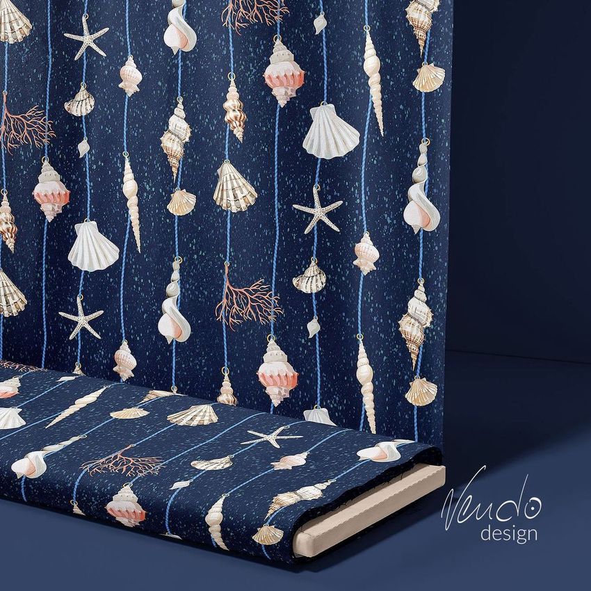 Fabric bolt mockup featuring a nautical pattern with shells, starfish, and corals on a dark blue background, shown in a studio setting.