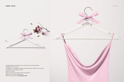 PSD mockup featuring a white hanger with floral accents and pink bow, displaying a pastel pink garment against a neutral backdrop.