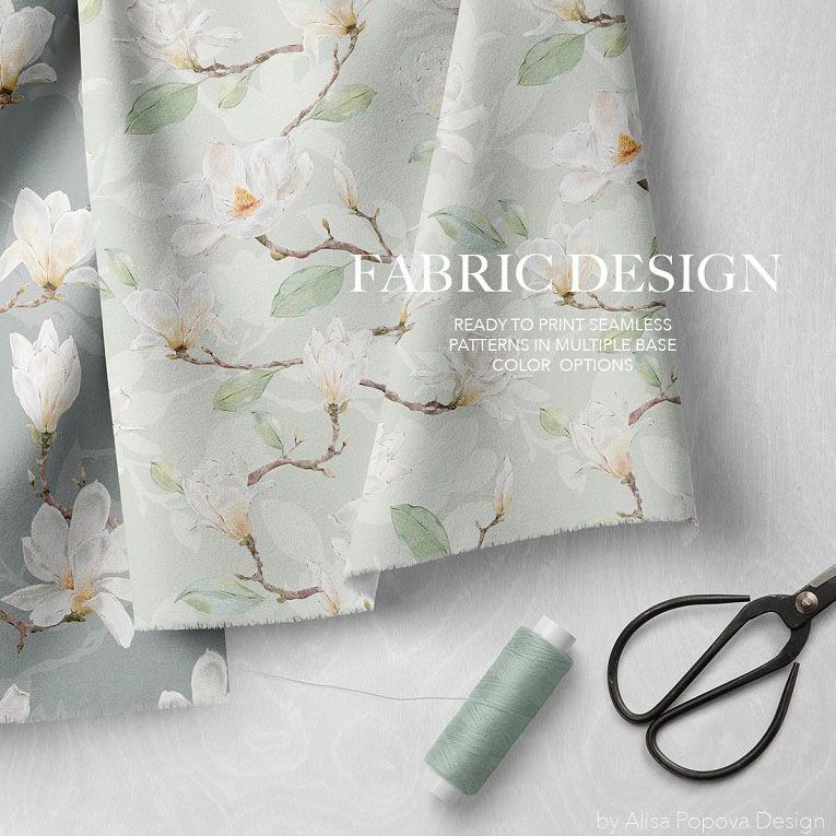 Hanging fabrics mockup featuring light green fabric with white magnolia flower patterns, shown with scissors and thread on a neutral surface.