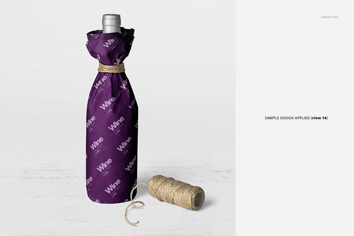 Mockup of a wine bottle covered in purple wrapping tissue paper, white lettering, and twine, shown from the front.
