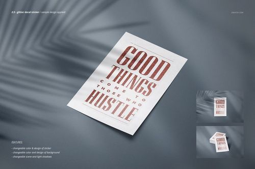 Rectangular decal sticker mockup with metallic text lying on a light surface, viewed from above with soft shadows.