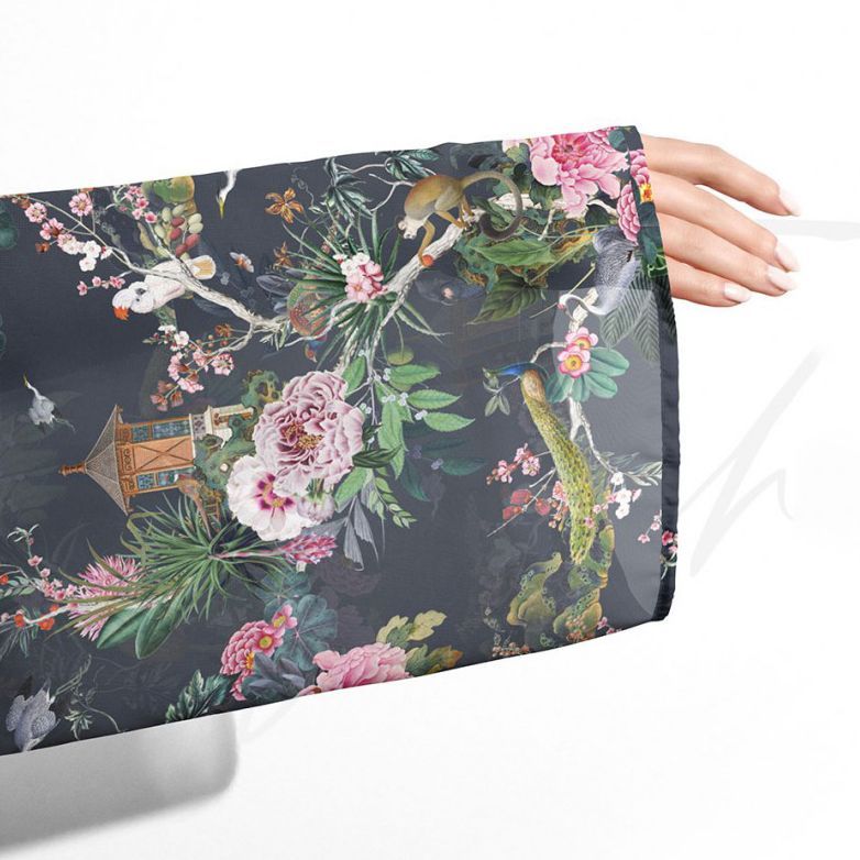 Chiffon kimono mockup featuring a close-up of a sleeve with a colorful botanical and animal pattern on a dark background.