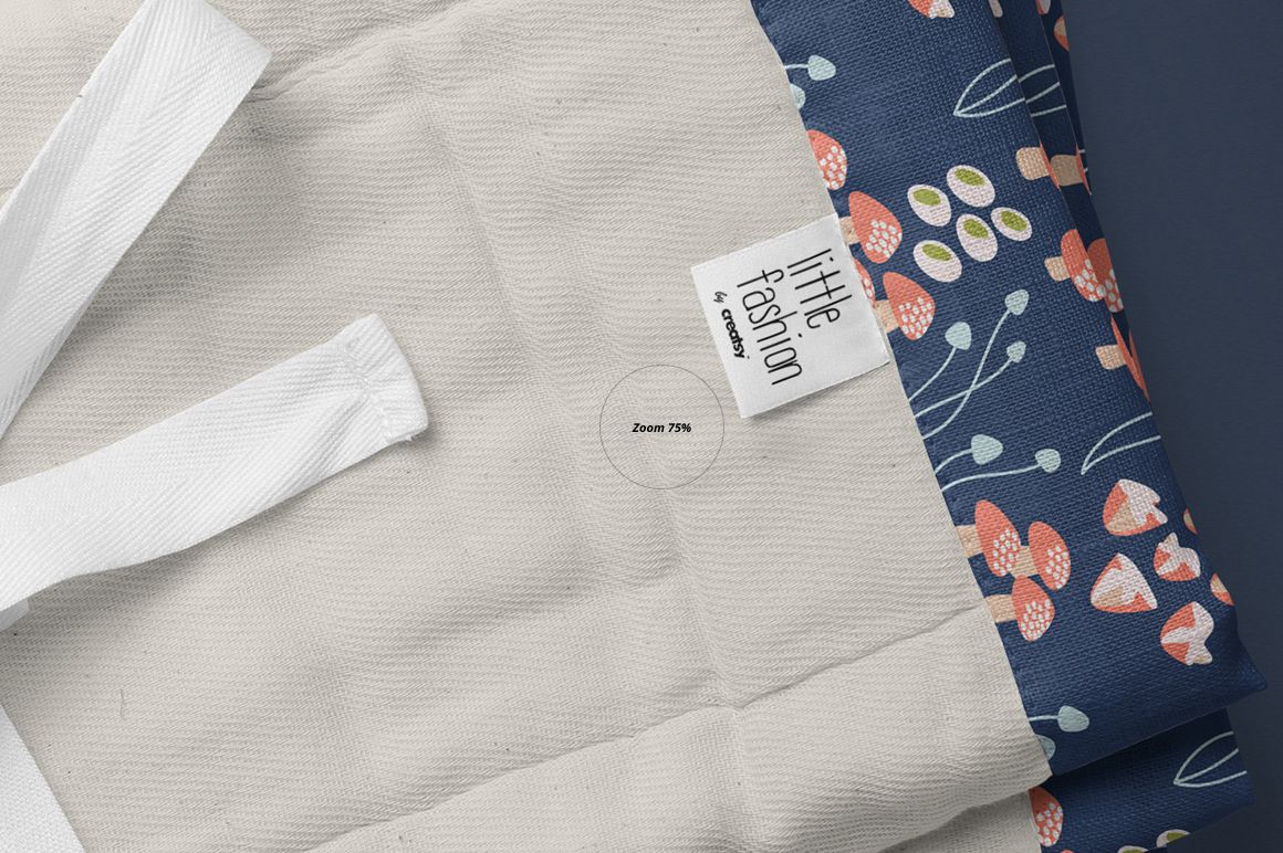 Burp cloth mockup featuring a close-up view of a beige fabric with a blue floral patterned edge and a visible label.