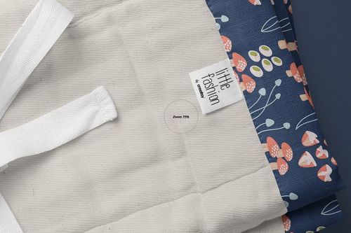Burp cloth mockup featuring a close-up view of a beige fabric with a blue floral patterned edge and a visible label.