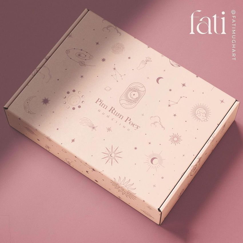 Mailing box mockup with celestial and mystical line art illustrations on a light pink surface, photographed on a pink background.