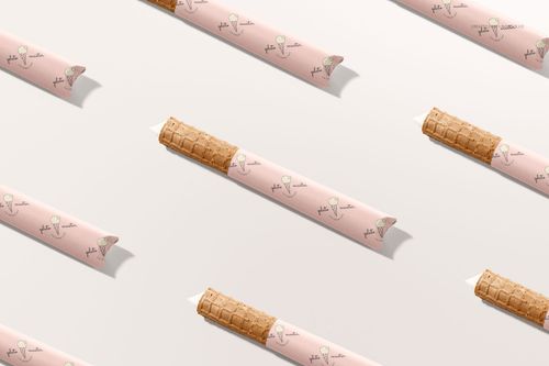 PSD mockup of ice cream wafer rolls with decorative pink wrappers and playful ice cream motifs, displayed in a repeating pattern.