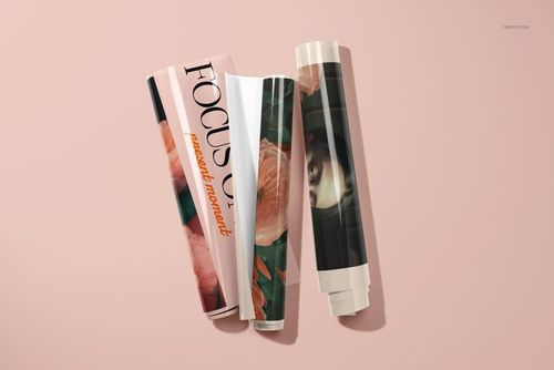 Rolled poster mockups featuring various designs, including flowers and a face, displayed on a soft pink background.