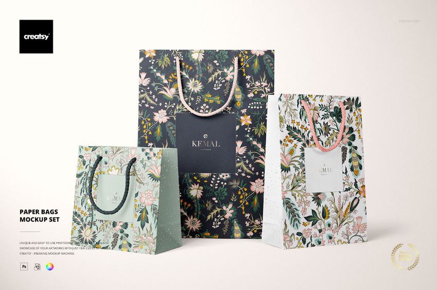Three paper bags with floral patterns in different colors and sizes, displayed upright on a light background.