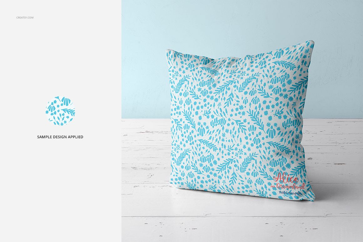 Fabric Factory vol.2 throw pillow mockup featuring a blue botanical design, shown from the front on a pale wood floor.