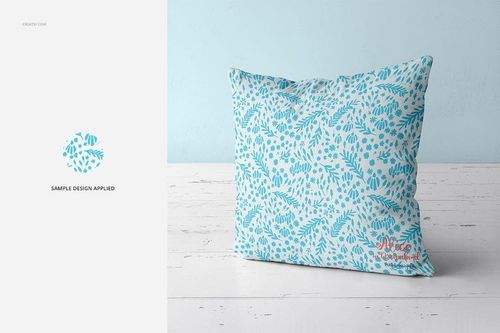 Fabric Factory vol.2 throw pillow mockup featuring a blue botanical design, shown from the front on a pale wood floor.