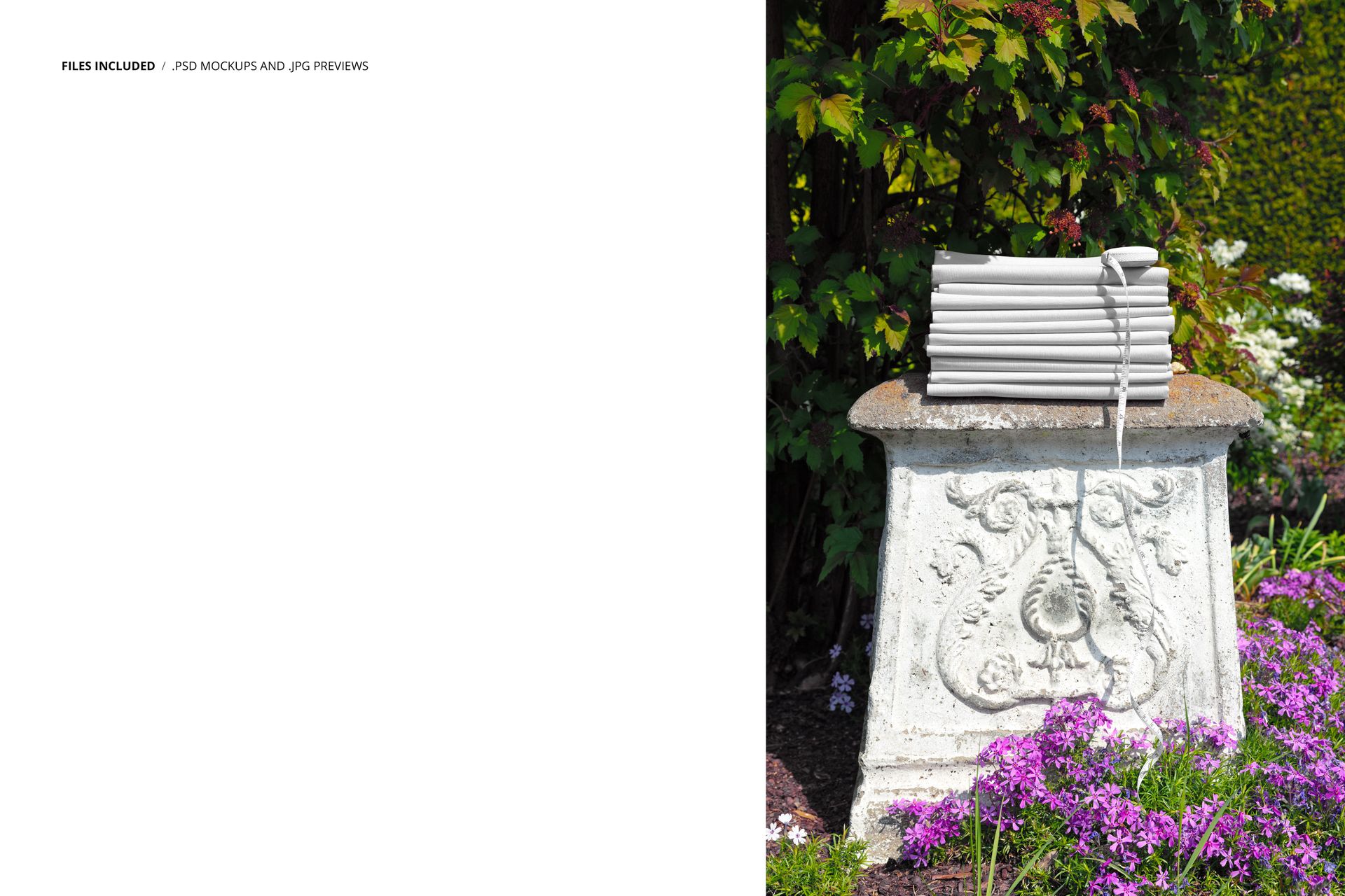 PSD mockup showing a pile of neutral-colored fabrics placed on a carved stone pedestal in a garden setting.