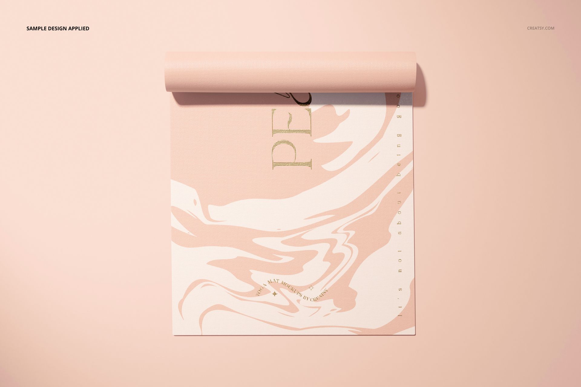 Rolled yoga mat mockup with a pink and cream marble pattern, viewed from above on a matching pastel background.