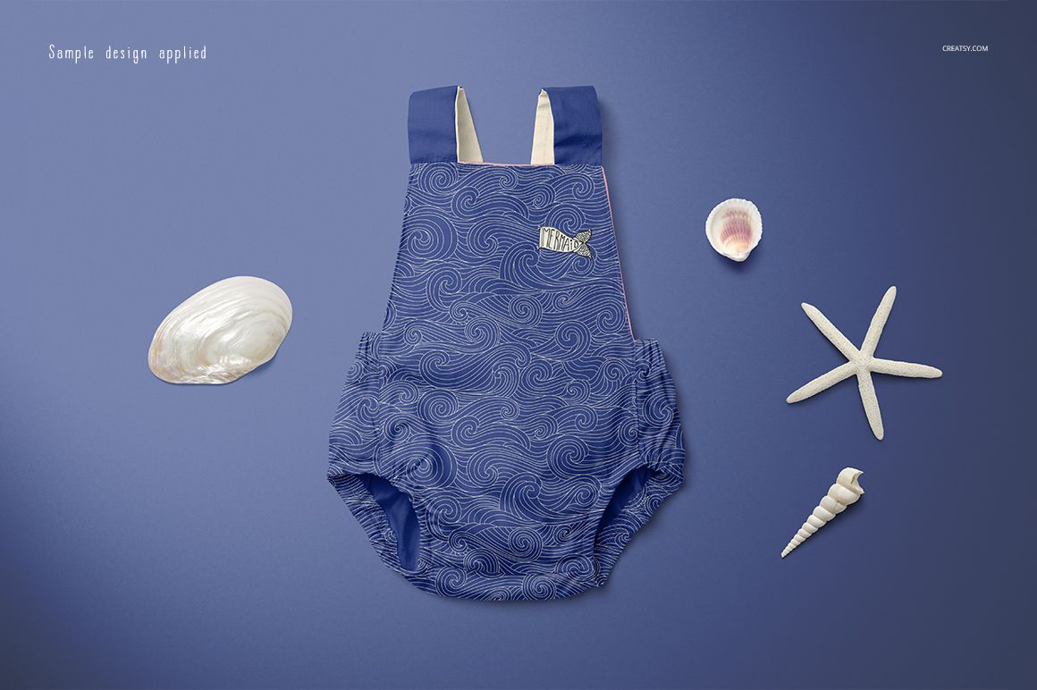 Blue baby romper mockup with swirling pattern, shown flat on a blue background alongside assorted sea shells and starfish.
