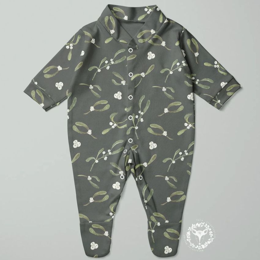 Babygrow sleepsuit mockup featuring a dark gray fabric with a green and white floral pattern, displayed flat on a light background.