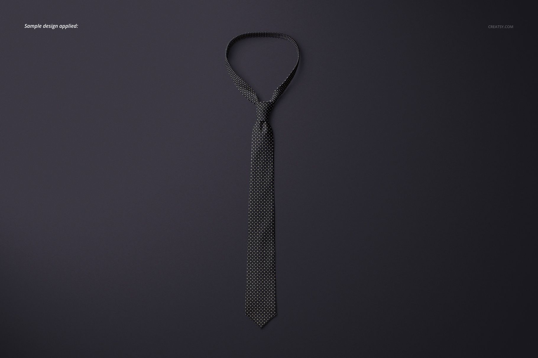 Single tie mockup featuring a subtle dotted design, arranged flat against a solid dark surface in overhead view.