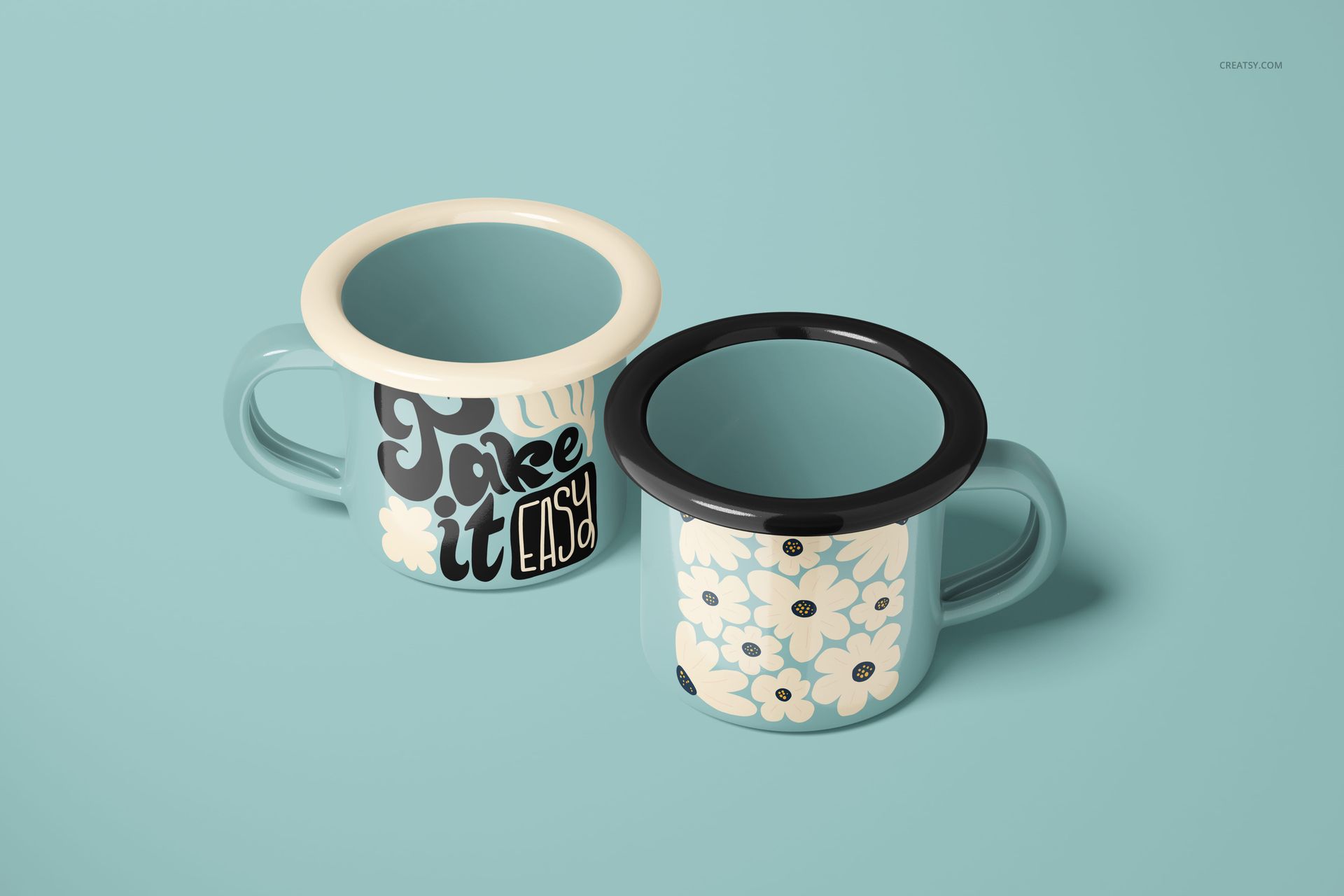 Two 100ml enamel mugs on a light blue surface, one with bold lettering and the other with a floral pattern, front view.
