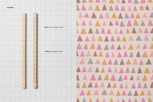 Top view of jersey fabric mockup with colorful triangle pattern and two wooden rulers on a grid background.