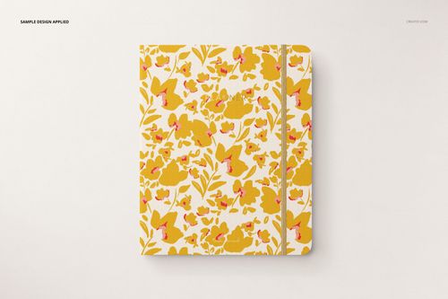 Stationery set mockup featuring a closed notebook with a white background and yellow floral design, top perspective.