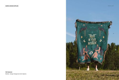 Fringed woven blanket mockup featuring a teal surface with artistic patterns, displayed outside on a green lawn.