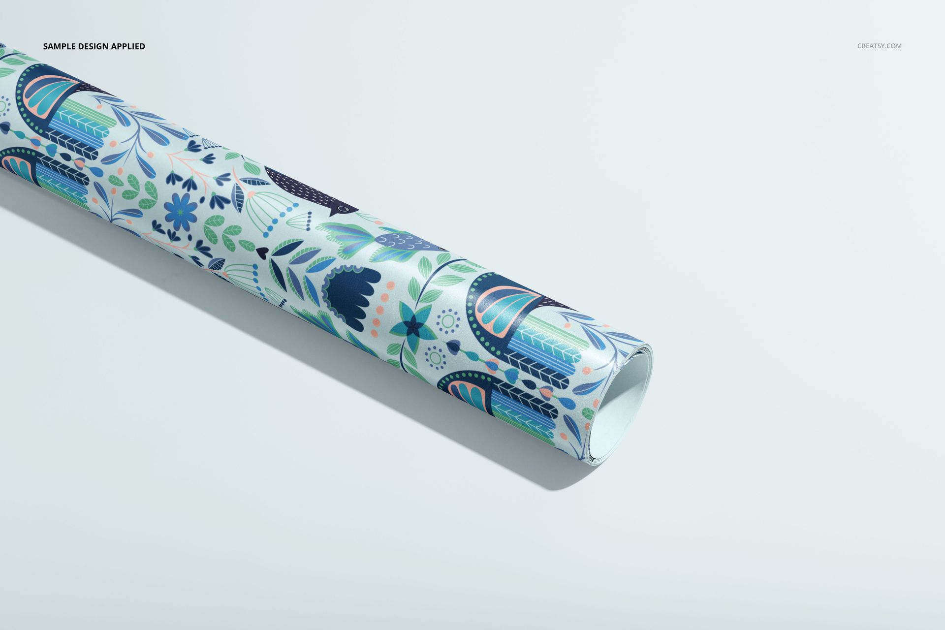 Gift wrapping paper PSD mockup displaying a tube with decorative botanical motifs in cool colors on a white background.