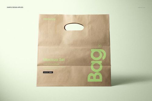 Die cut kraft paper bag mockup displayed upright, showing a cutout handle and green printed details on brown paper.