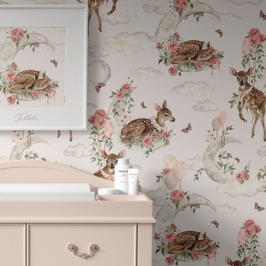 Baby room changing pad mockup featuring a cream dresser with a padded top, set against wallpaper with deer, moons, and floral patterns.