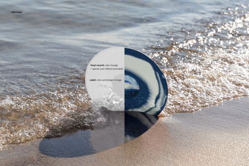 PSD mockup featuring a vinyl record stuck in sand by shoreline, with foamy waves and soft natural lighting.