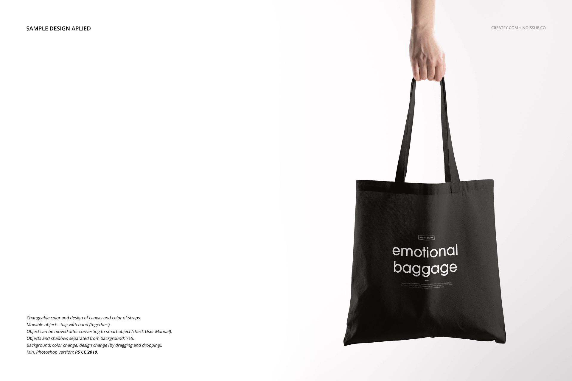 Front view of a black tote bag mockup held by a hand, featuring white text design, on a plain background.