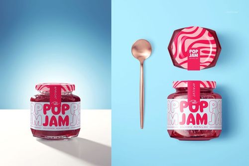 PSD mockup of a raspberry jam jar featuring a colorful pink label, displayed alongside a metallic spoon on a blue surface.