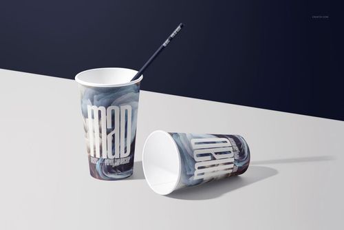 Paper cup mockup featuring two cups with swirling blue designs, one standing with a straw, one resting horizontally.