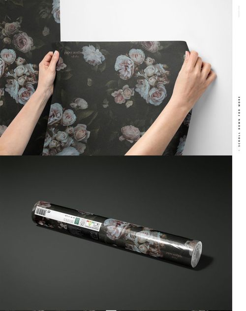 Hands applying dark floral non-woven vinyl wallpaper with pink and white roses, shown from a front view.