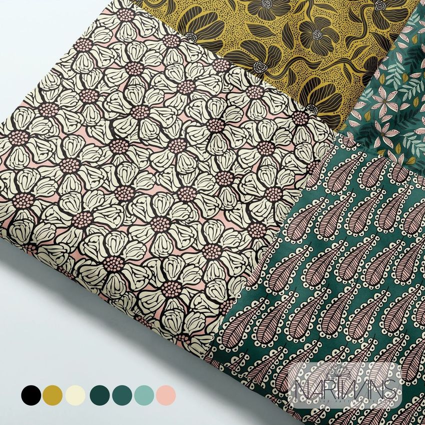 Baby patchwork quilt mockup featuring four distinct fabric patterns in earthy green, cream, yellow, and pink tones, viewed from above.