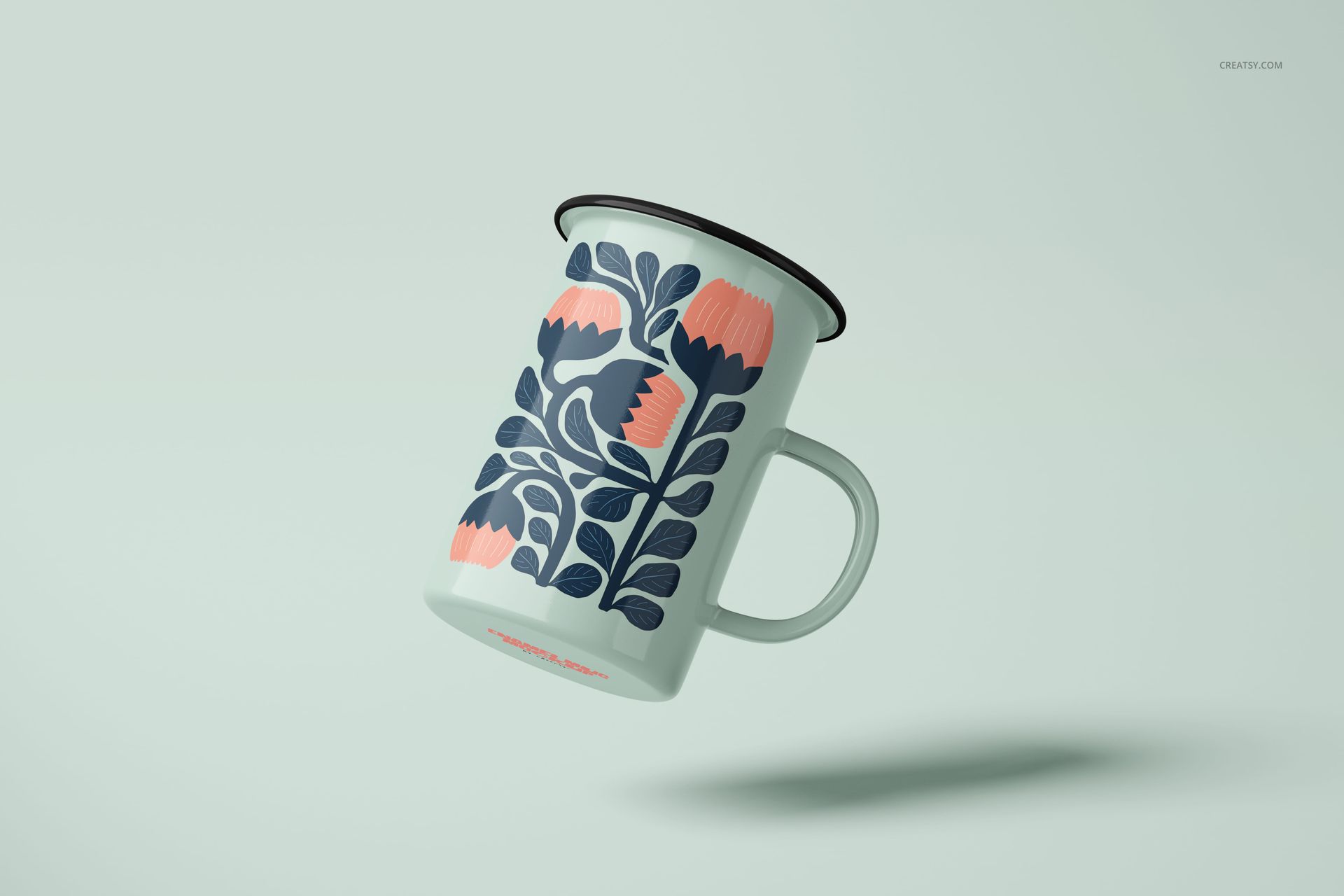 450ml enamel mug mockup featuring a botanical design in dark blue and pink, displayed at an angle on pale backdrop.