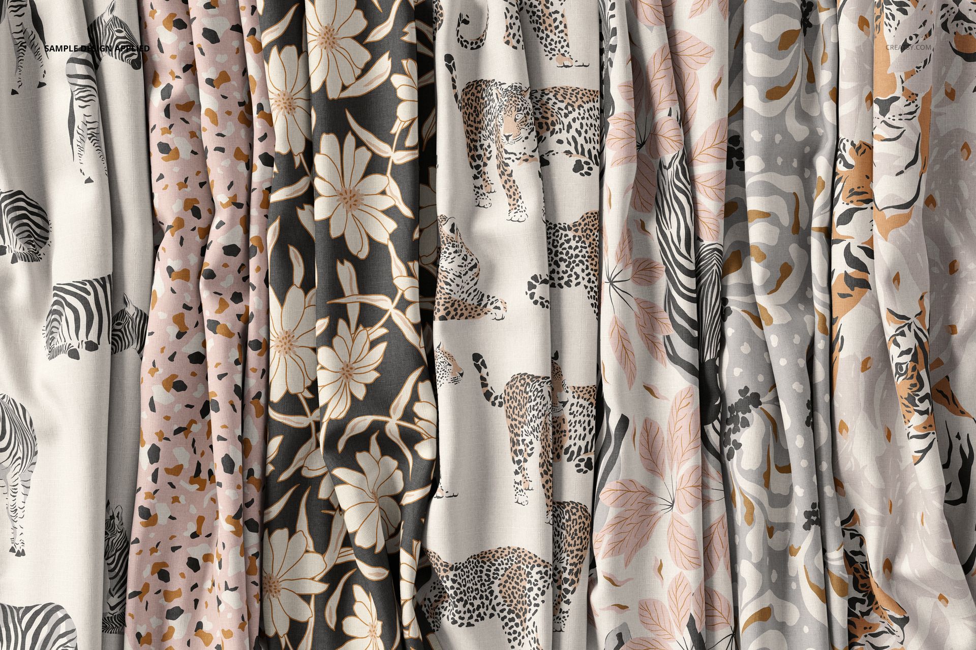 Front view of creased fabric mockup featuring various animal and floral patterns in neutral and pastel colors.