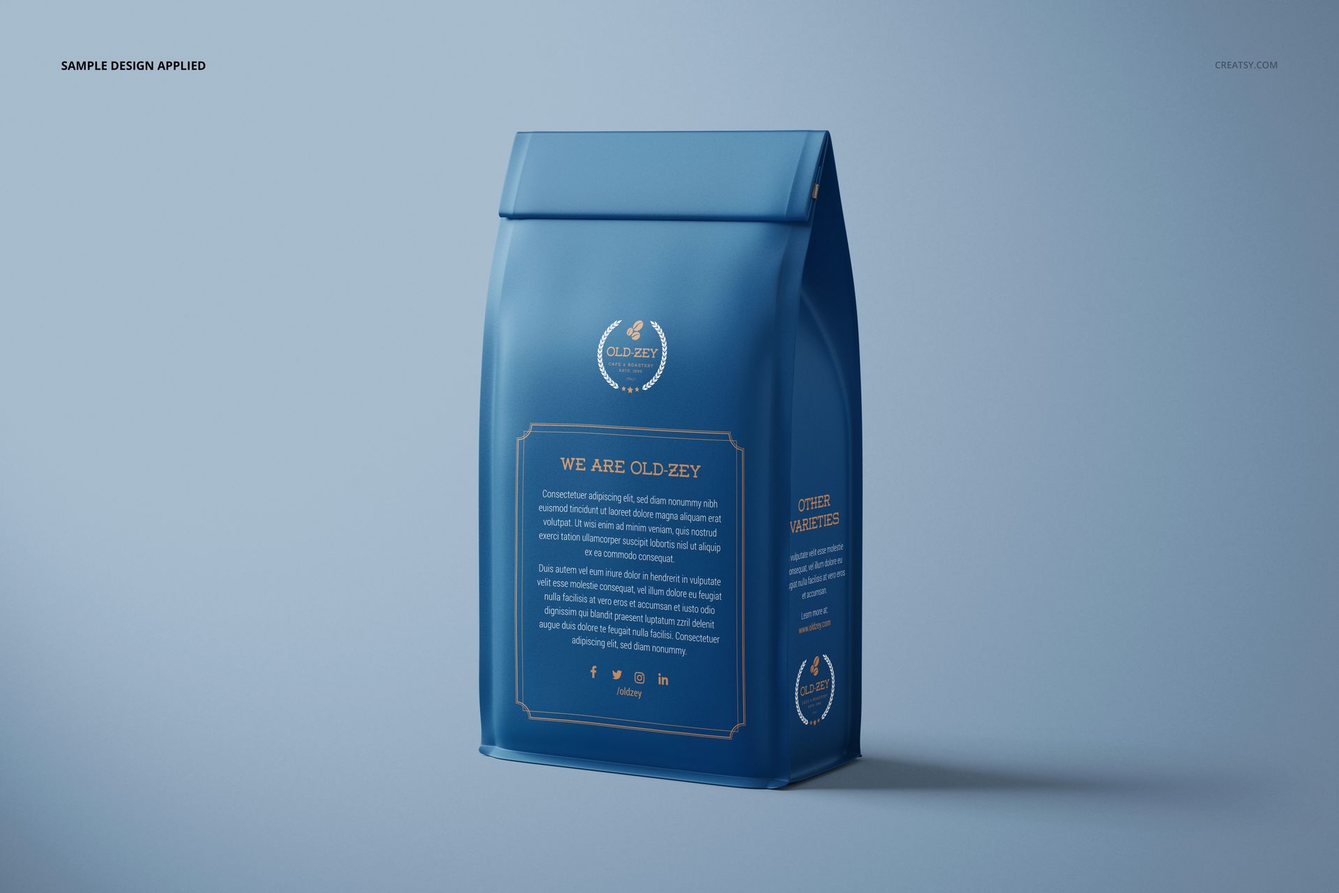 Blue paper coffee bag mockup with gold outlined label and text, displayed against a minimalist light background.