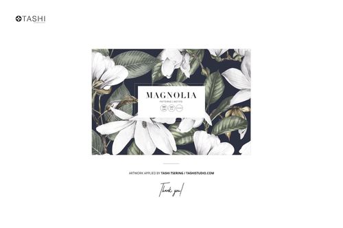 Floating fabric mockup displaying a magnolia floral pattern with white flowers and green leaves on a dark background, front view.