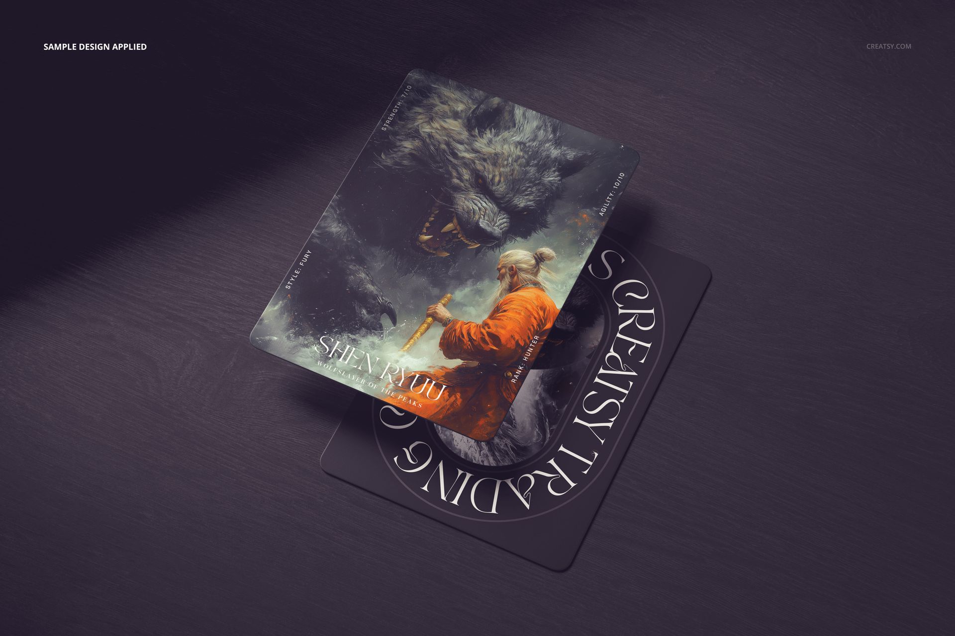 Stacked trading cards mockup with one card showing a warrior and wolf artwork, viewed from above on a dark table.