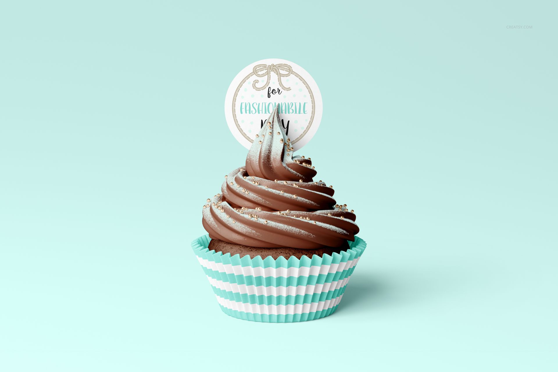 Cupcake mockup featuring chocolate frosting, circular topper, and striped wrap, shown from the front on blue backdrop.