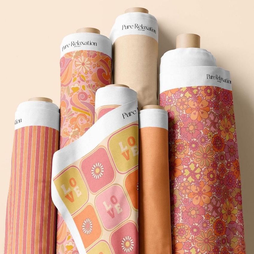 Fabric rolls mockup featuring seven rolls with colorful summer-themed patterns in orange, pink, and yellow tones on a neutral background.